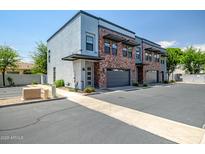 Modern townhome exterior boasts brick accents, private garages, and sleek architectural details at 240 W Missouri Ave # 1, Phoenix, AZ 85013
