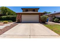 Charming home featuring a brick-accented garage and extended driveway at 3705 W Villa Theresa Dr, Glendale, AZ 85308
