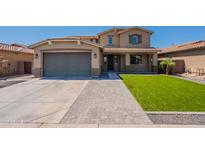 Inviting two-story home featuring a manicured lawn, stylish garage, and charming entrance at 408 W Sweet Shrub Ave, San Tan Valley, AZ 85140