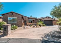 Inviting single-story brick and stucco home with desert landscaping and spacious driveway at 11070 E Bent Tree Dr, Scottsdale, AZ 85262