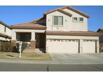 Two-story home with three-car garage, well-maintained lawn and desert landscaping at 11210 W Alvarado Rd, Avondale, AZ 85392
