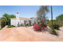 Charming home featuring brick driveway, desert landscaping, mature trees, and white exterior at 1441 E Hubbell St, Phoenix, AZ 85006