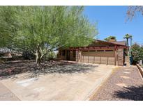 Charming home featuring a large, mature tree providing ample shade in the front yard at 1844 W Virginia Ave, Phoenix, AZ 85007