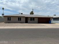Charming single-story home featuring a brick facade, attached garage and low maintenance landscaping at 3545 W Georgia Ave, Phoenix, AZ 85019