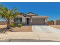 Beautiful single-story home featuring desert landscaping, stone accents and a spacious two-car garage at 40913 W Williams Way, Maricopa, AZ 85138