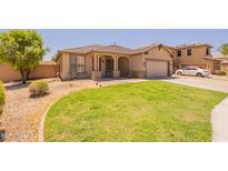 Charming single-story home with a well-manicured lawn and covered front porch at 888 S 165Th Ln, Goodyear, AZ 85338