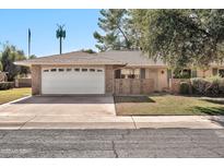 Charming single-story home with a well-maintained yard and a two-car garage at 10205 W Royal Oak Rd, Sun City, AZ 85351