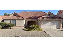 Charming single-story home with a well-maintained front yard, tile roof, and an attached garage at 1249 E Commerce Ave, Gilbert, AZ 85234