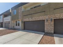 Modern two-story townhome with private garage, stone accents, and clean architectural lines at 2000 N 36Th St # 41, Phoenix, AZ 85008
