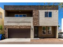 Modern two-story home featuring a two-car garage and tasteful stone accents at 2000 N 36Th St # 8, Phoenix, AZ 85008