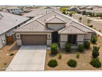 Charming single-story home featuring a well-maintained desert landscape and a two car garage at 22657 N 184Th Ln, Surprise, AZ 85387