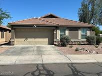Charming single-story home with a well-maintained front yard and a two-car garage at 29954 N Broken Shale Dr, San Tan Valley, AZ 85143
