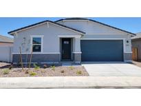 Charming single-story home showcasing a blue garage door and professionally landscaped front yard at 3805 N Camden Dr, Florence, AZ 85132