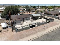 Charming single-story home featuring a carport, pool and a secure gated yard at 404 E Centre Ave, Buckeye, AZ 85326