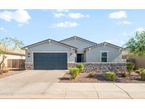 Charming single-story home featuring a neatly manicured yard and a stylish stone accent wall at 4143 E Sidesaddle Rd, San Tan Valley, AZ 85140