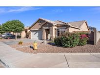 Charming single-story home featuring desert landscaping, a tile roof, and a two-car garage at 671 W Jahns Ct, Casa Grande, AZ 85122