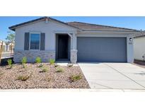 Charming single-story home featuring a gray garage door and shuttered window at 8560 W Yorktown Ct, Florence, AZ 85132