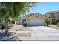 Charming single-level home featuring a two-car garage and well-maintained landscaping at 13959 W Country Gables Dr, Surprise, AZ 85379