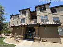 Inviting condo complex featuring a tile roof, desert landscaping, and a welcoming entrance at 14950 W Mountain View Blvd # 7202, Surprise, AZ 85374