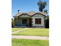 Charming single-story home featuring brick accents, a well-maintained lawn, and a classic architectural style at 1625 W Vernon Ave, Phoenix, AZ 85007