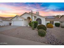 Charming single-story home with a well-manicured front yard and solar panels on the roof at 16426 N 49Th St, Scottsdale, AZ 85254