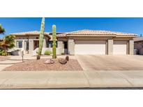 Charming single-story home with desert landscaping and a three-car garage at 20017 N Cielo Ct, Surprise, AZ 85374