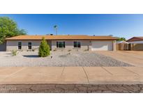 Charming single-story home features a low-maintenance desert landscape, attached garage and freshly painted exterior at 3433 E Betty Elyse Ln, Phoenix, AZ 85032