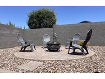 Outdoor fire pit with Adirondack chairs creates an inviting space for relaxation and gatherings at 500 W Nikita Dr, San Tan Valley, AZ 85140