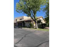 Beige two-story home featuring a tile roof and low-maintenance landscaping at 6223 N 12Th St # 1, Phoenix, AZ 85014