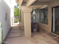 Covered patio space with tiled floor and view of gated walkway at 9728 N 106Th Pl # 154, Scottsdale, AZ 85258