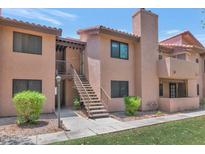 Charming two-story condo with stairs leading to the front entrance at 1075 E Chandler Blvd # 210, Chandler, AZ 85225