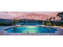 Beautiful backyard pool overlooking the golf course and lake at sunset at 16239 S 18Th Pl, Phoenix, AZ 85048