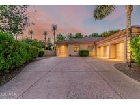 Well-maintained driveway leads to a three-car garage, surrounded by mature landscaping and a tile roof at 1758 E Carver Rd, Tempe, AZ 85284