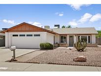 Charming single-story home with desert landscaping, a two-car garage and mature cacti at 2745 E Dahlia Dr, Phoenix, AZ 85032