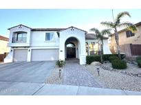 Charming two-story home with a three-car garage and a well-manicured front yard at 34116 N 23Rd Dr, Phoenix, AZ 85085