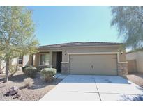 Charming single-story home featuring a two-car garage, low maintenance landscaping, and a welcoming entrance at 38133 W Vera Cruz Dr, Maricopa, AZ 85138