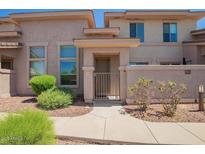 Charming condo featuring a private gated courtyard and neutral-tone stucco exterior at 42424 N Gavilan Peak Pkwy # 57104, Anthem, AZ 85086
