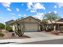 Charming single-story home featuring a two-car garage, desert landscaping, and a welcoming facade at 6205 W Encinas Ln, Phoenix, AZ 85043
