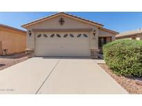 Charming single-story home featuring a large garage, desert landscaping, and a well-maintained front yard at 857 E Impreria St, San Tan Valley, AZ 85140