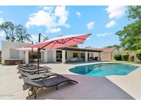 Inviting backyard features a sparkling pool with lounge chairs and a covered patio, perfect for outdoor entertaining at 12835 N 78Th St, Scottsdale, AZ 85260