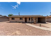 Charming single-story home featuring a gravel yard, quaint fountain, and convenient carport at 1545 W 7Th Ave, Mesa, AZ 85202