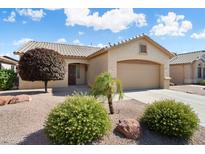 Charming single-story home featuring a two-car garage, neutral paint, desert landscaping and a lovely, sunny curb appeal at 17653 W Ingleside Dr, Surprise, AZ 85374