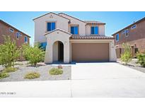 Charming two-story home featuring a stucco facade, tile roof, and a two-car garage at 19889 W Annika Dr, Litchfield Park, AZ 85340