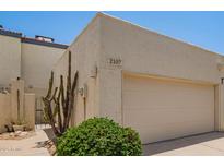 Cozy home featuring a two-car garage, desert landscaping, and a private gated entry at 2107 W Lane Ave, Phoenix, AZ 85021
