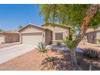 Charming single-story home featuring low-maintenance desert landscaping and an attached two-car garage at 21311 N Shelby Ct, Maricopa, AZ 85138