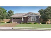 Charming single-story home with a well-manicured lawn and a two-car garage at 23113 E Saddle Way, Queen Creek, AZ 85142