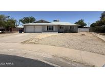 Charming single story home featuring a spacious front yard and a two-car garage in a quiet neighborhood at 324 E Riviera Dr, Tempe, AZ 85282