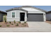 Charming single-story home featuring a gray exterior, landscaped front yard, and a two-car garage at 3498 N Camden Dr, Florence, AZ 85132