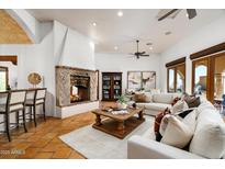 Spacious living room with a fireplace, comfortable seating, and stylish decor at 40039 N 107Th Pl, Scottsdale, AZ 85262