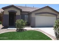 Charming single-story home featuring a well-manicured lawn and a neutral color scheme at 46129 W Barbara Ln, Maricopa, AZ 85139
